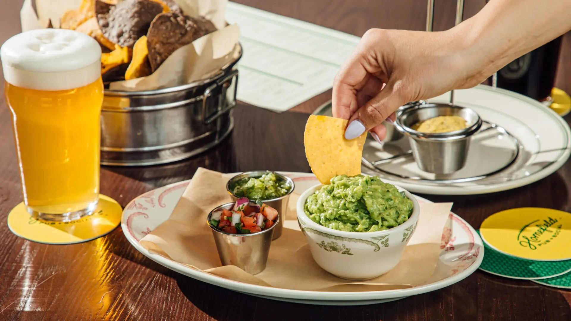 Cinco de Mayo Dipping a nacho chip into guacamole