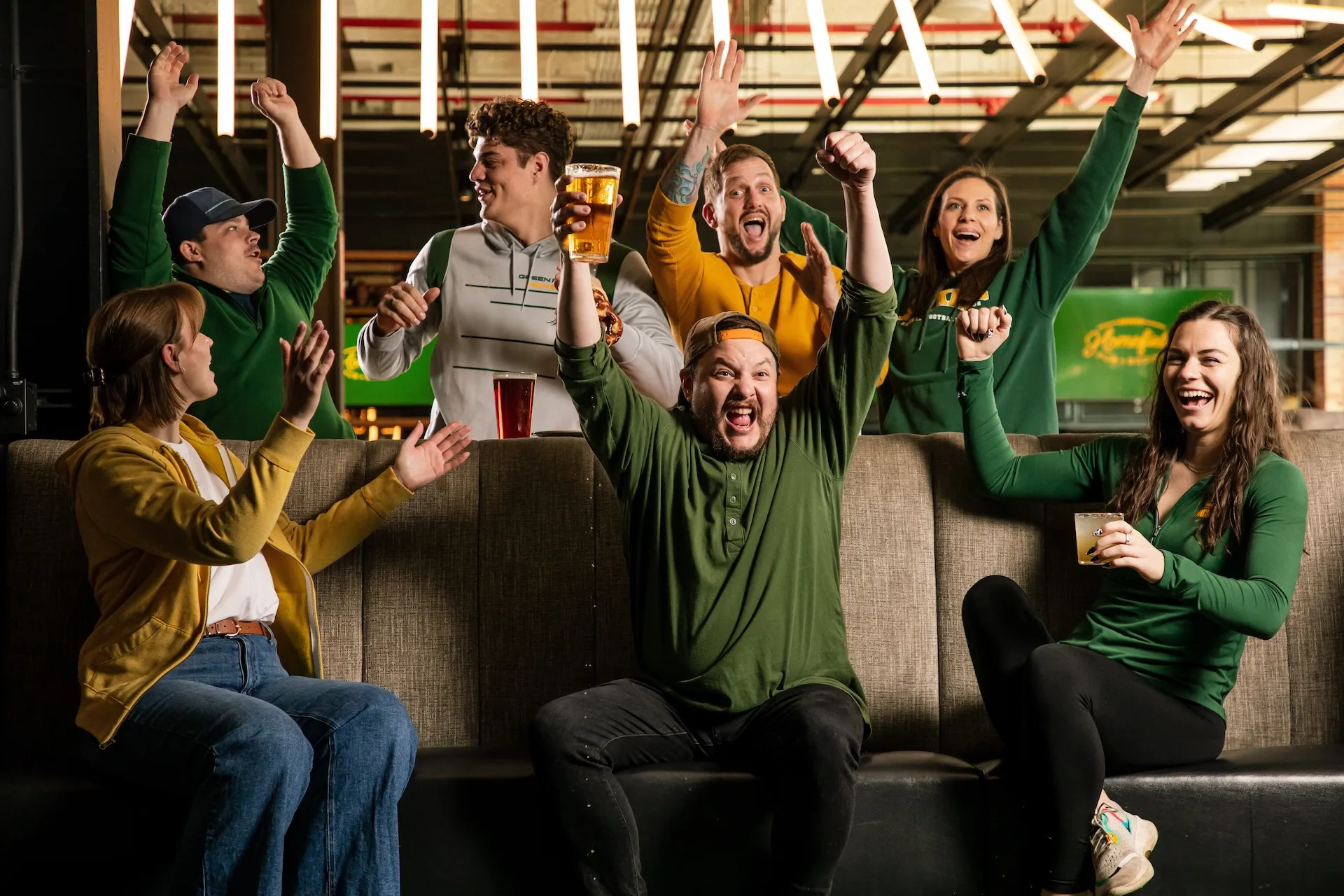 Group of people holding drinks and celebrating together